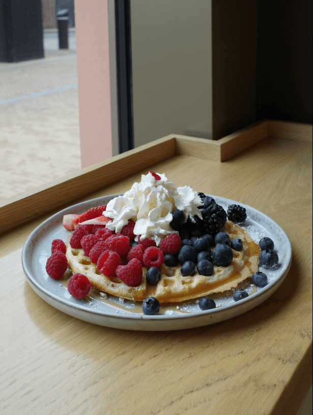 Berry-topped waffles served at Bridge St Coffee